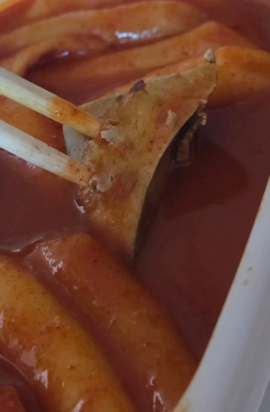 Spooning up tteokbokki broth