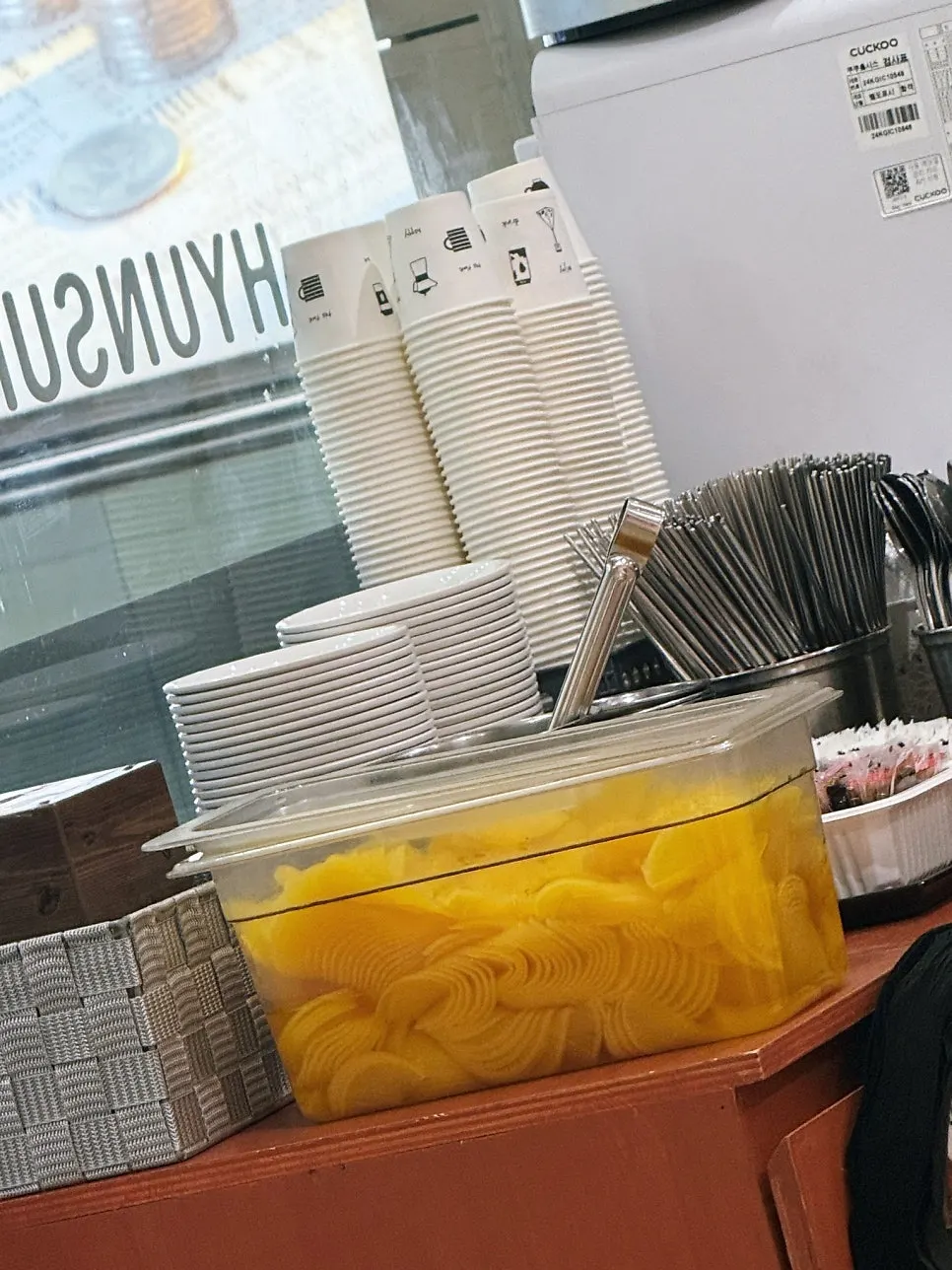 Self-serve bar with personal plates, utensils, and pickled radish