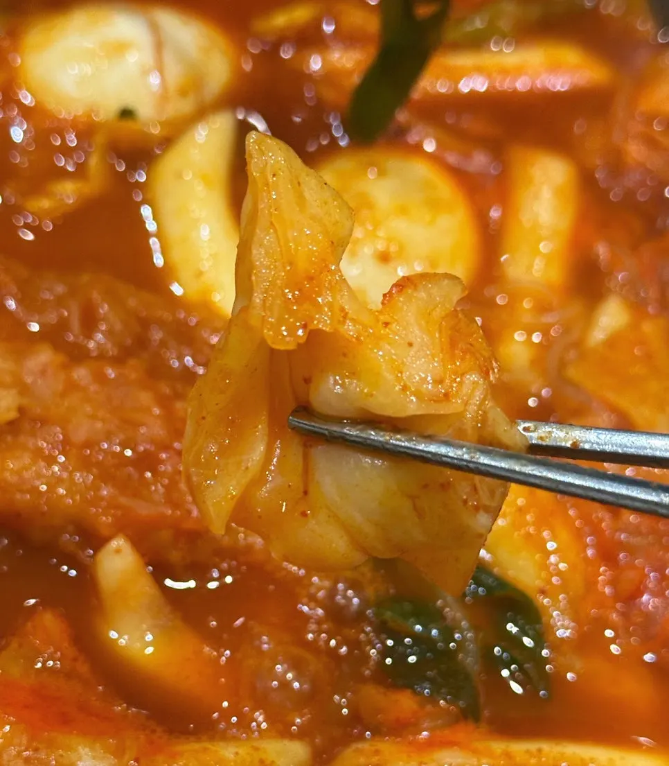 Pot of instant tteokbokki packed with cabbage