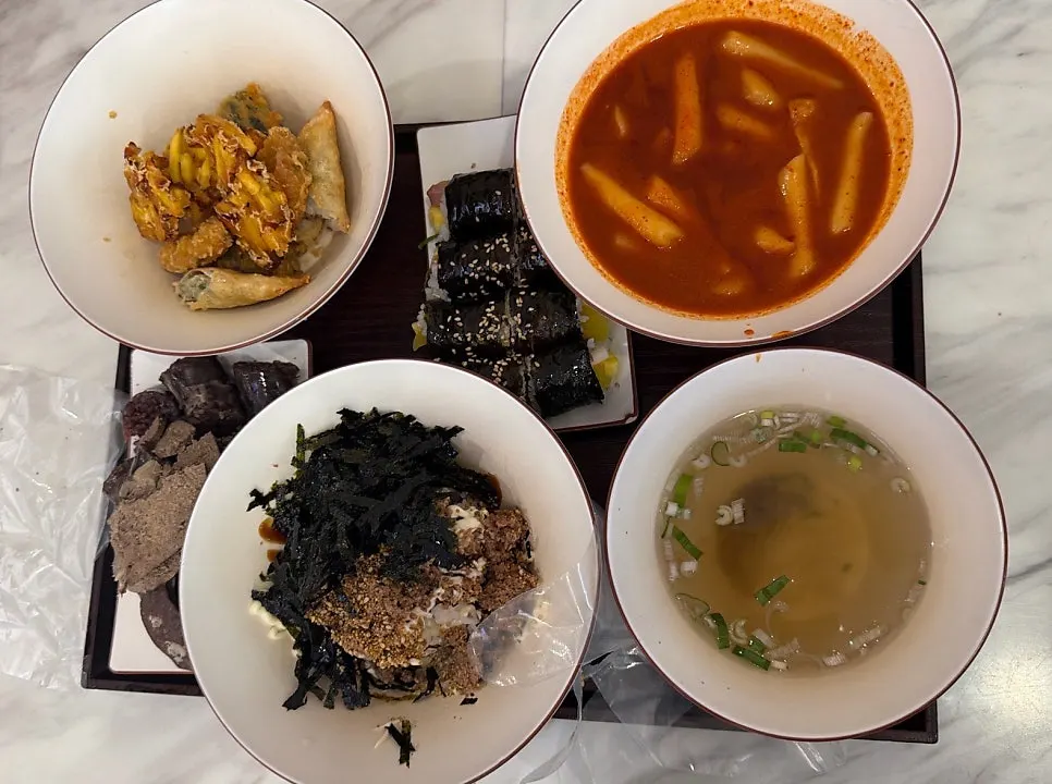 Hyeonseoni Set and tuna mayo rice bowl laid out on an outdoor table