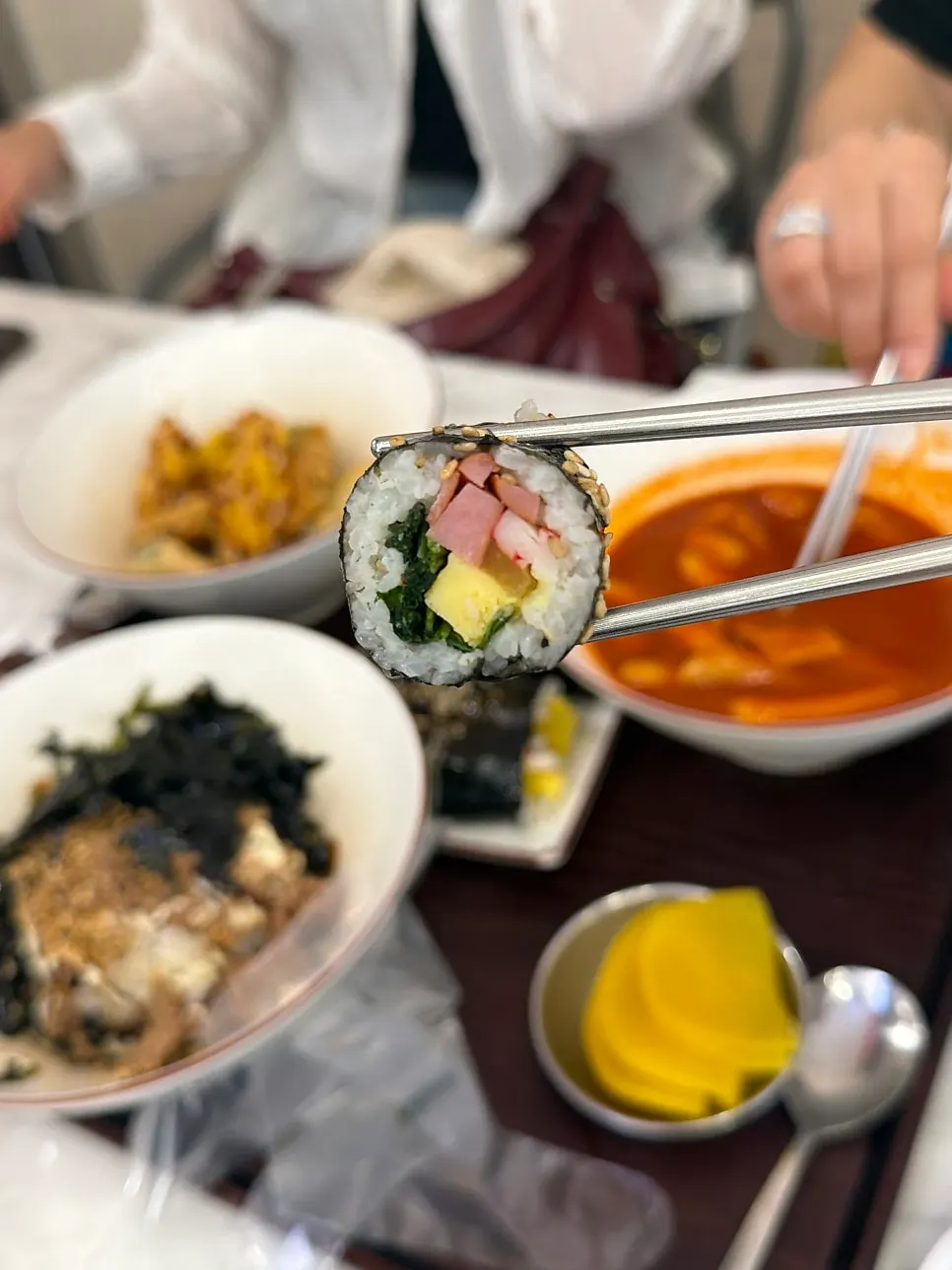 Plate of mild-spice tteokbokki, mini gimbap, and fried snacks