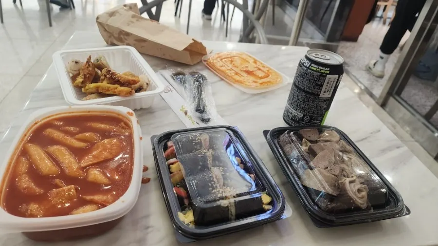 Bunsik table setting with tteokbokki, gimbap, and fried snacks together