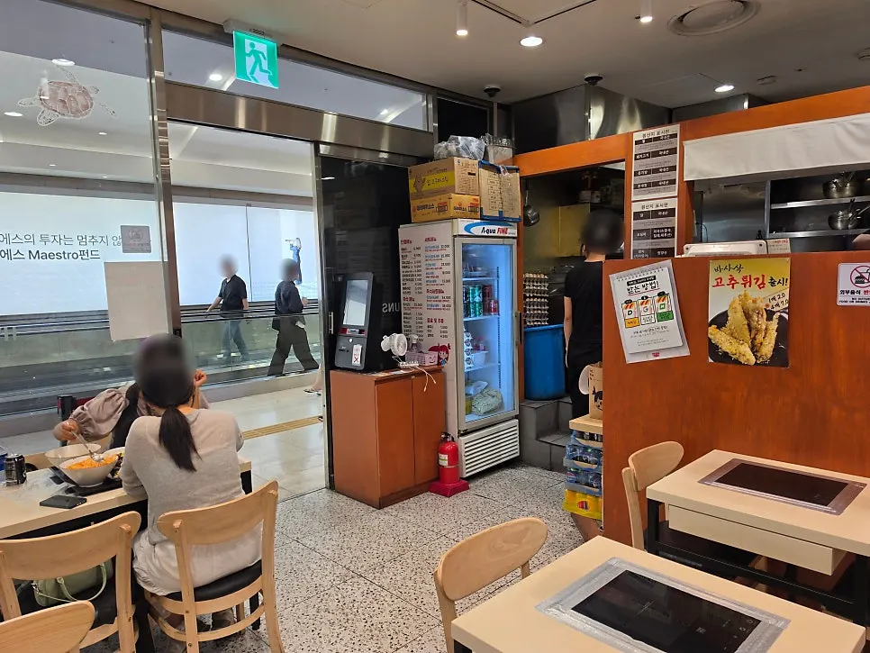 Dining tables in the space next to the convenience store