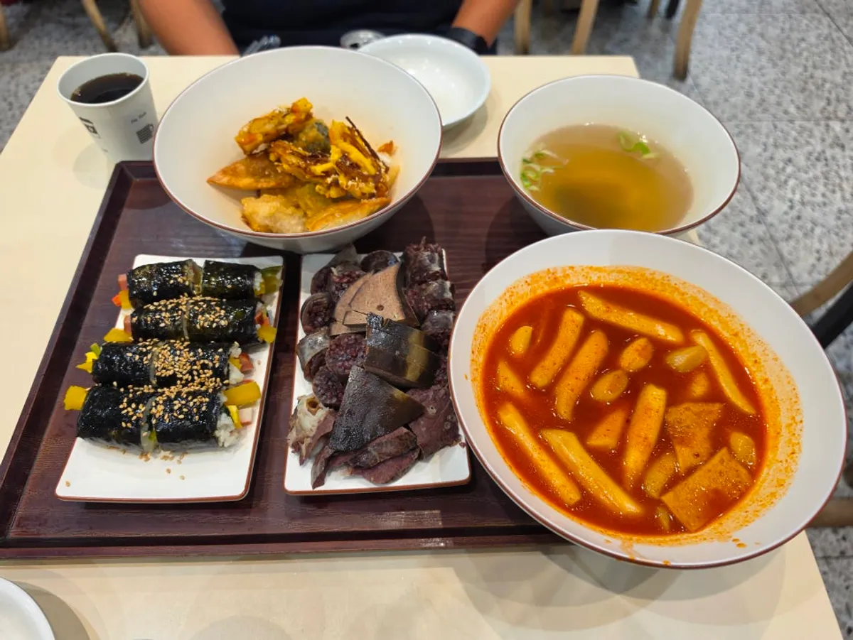 Full Hyeonseoni Set spread with tteokbokki, fried snacks, sundae, and gimbap