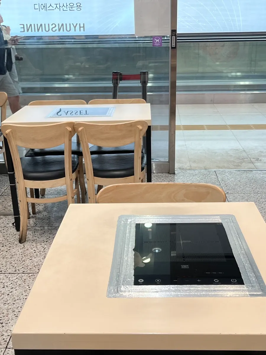 Tables and customers toward the back of the store