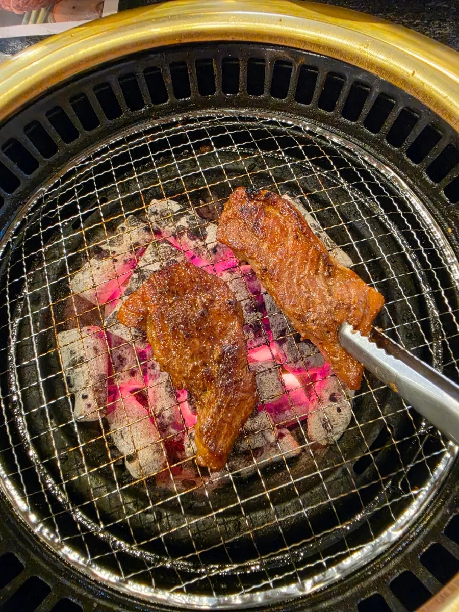 Staff grilling the pork ribs front and back