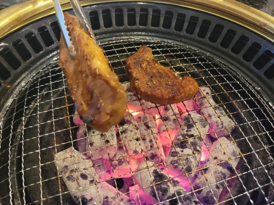 Partially cooked pork ribs set aside on the grill