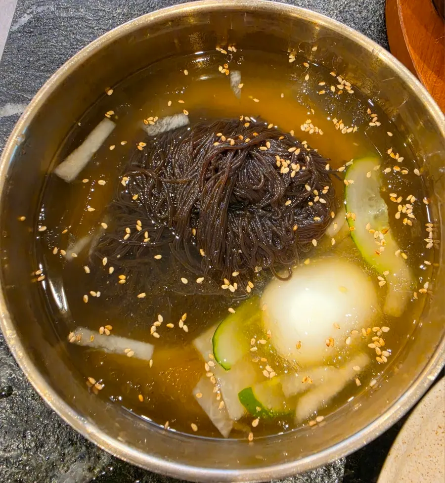 Water naengmyeon served alongside the pork ribs