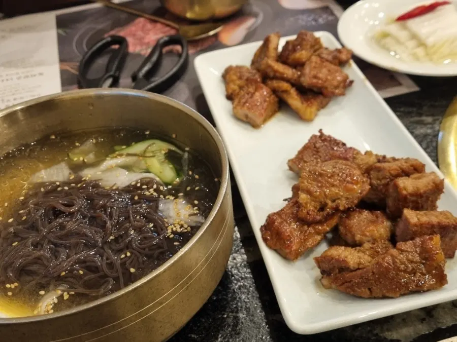 Marinated pork ribs piled on top of naengmyeon