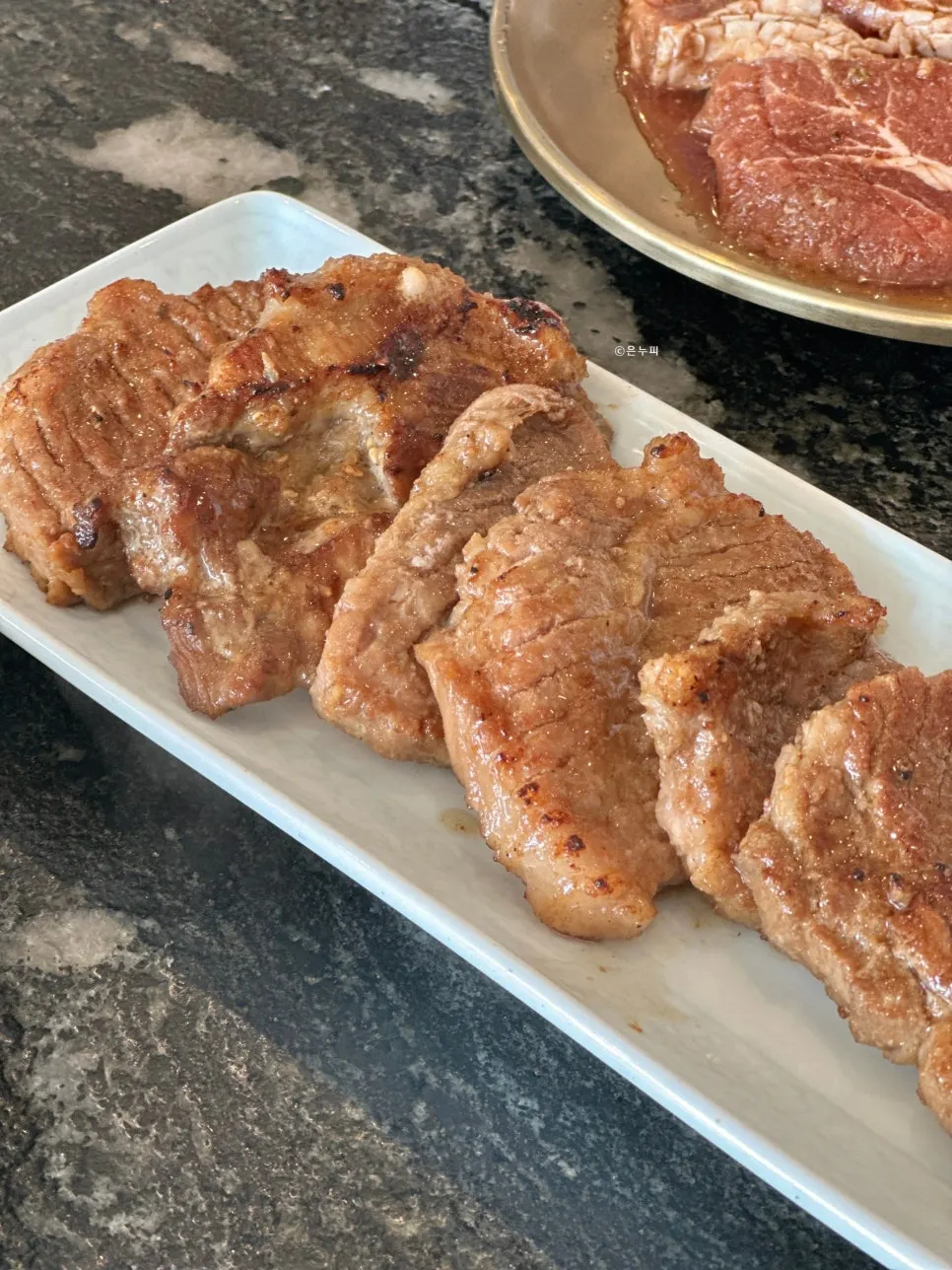 Seasoned pork ribs browning nicely on the grill