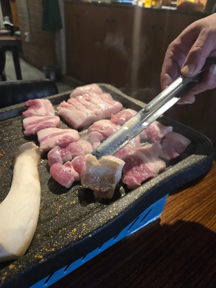Fresh pork belly and whole pork jowl on the grill