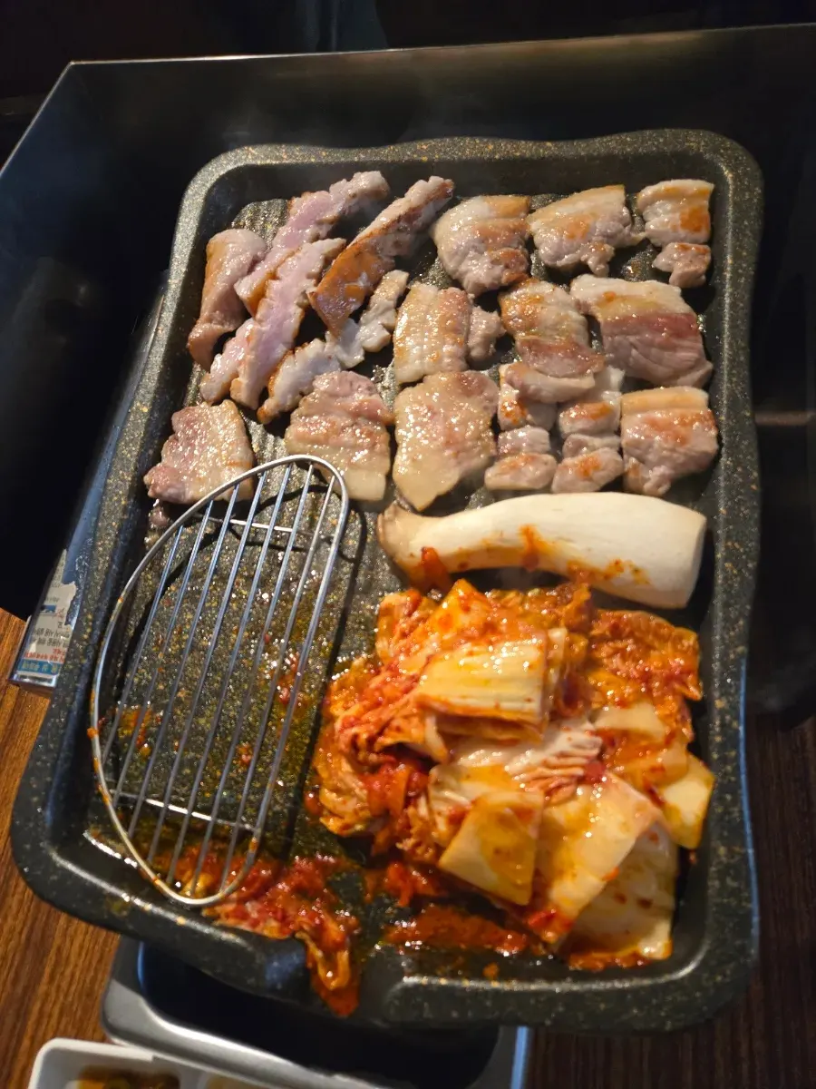 Generous pile of kimchi placed next to the meat