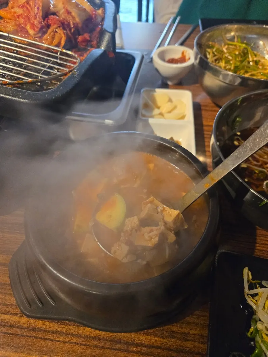 Close-up of tofu and vegetables inside the doenjang jjigae