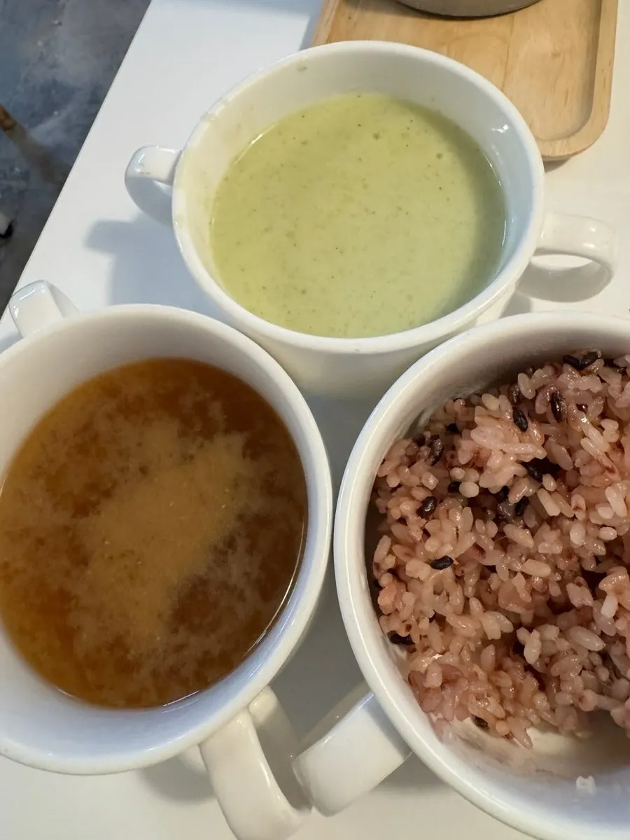 Full table setting with rice, salad, and soup served together