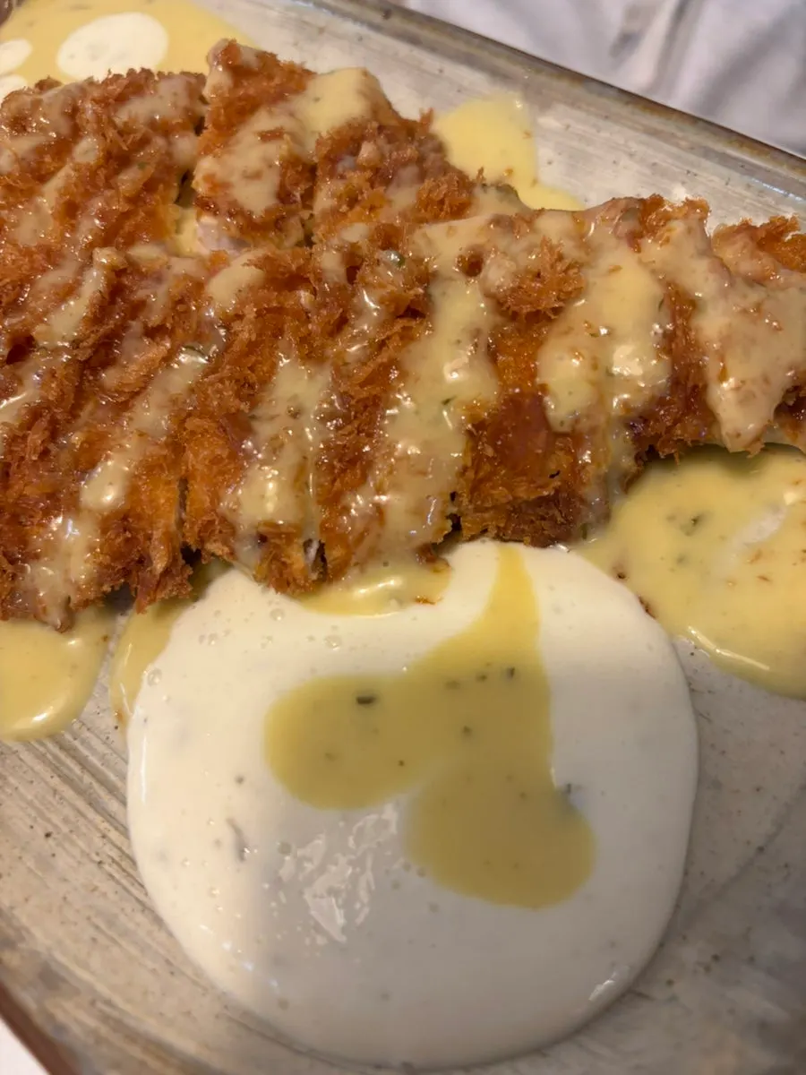 Plate of chicken katsu with a side of cabbage salad