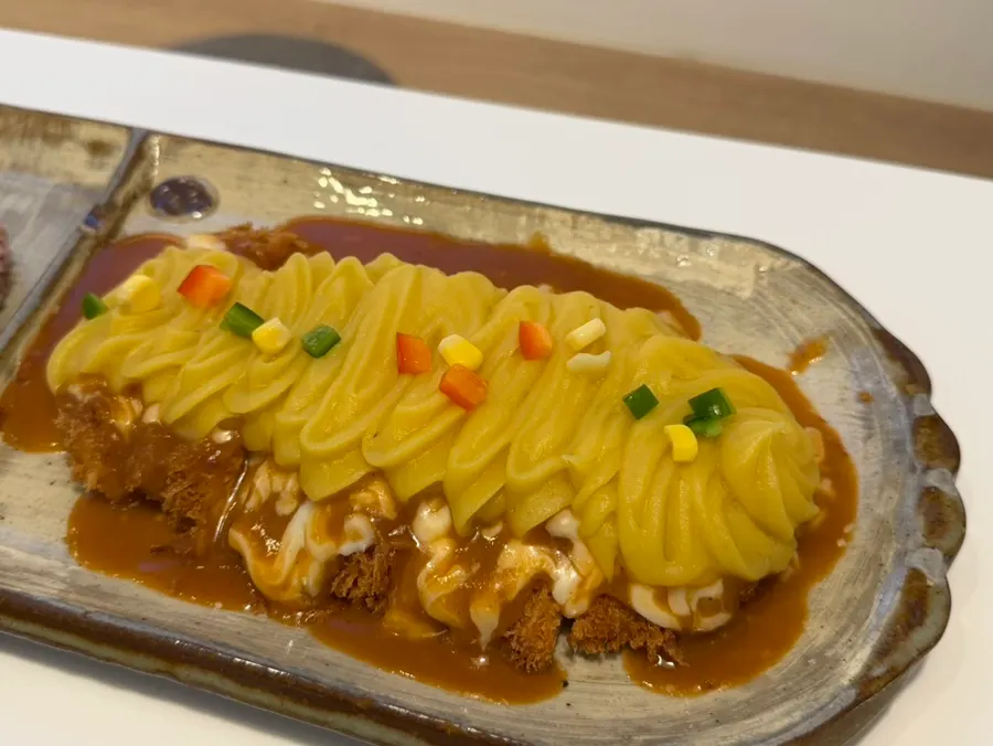 Cross-section of the cheese katsu piled high with sweet potato mousse
