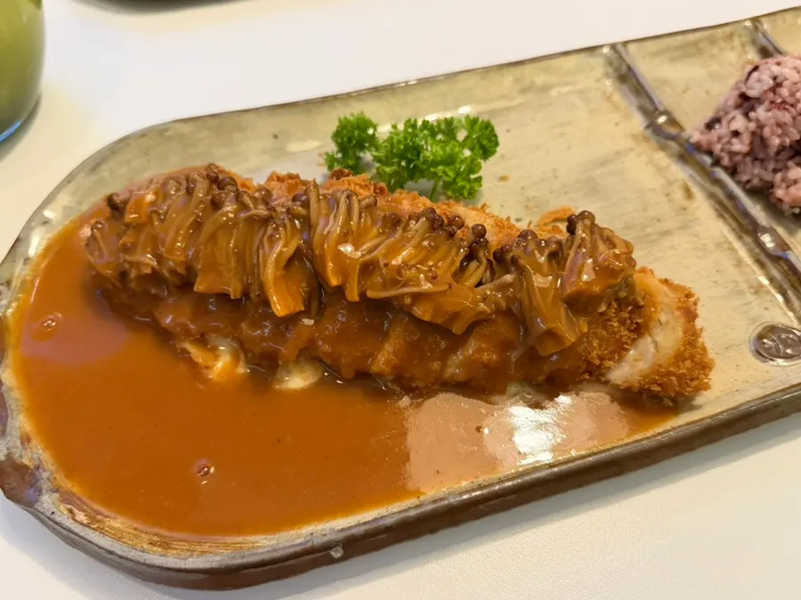 Mushrooms soaked in sauce on top of the cheese roll katsu