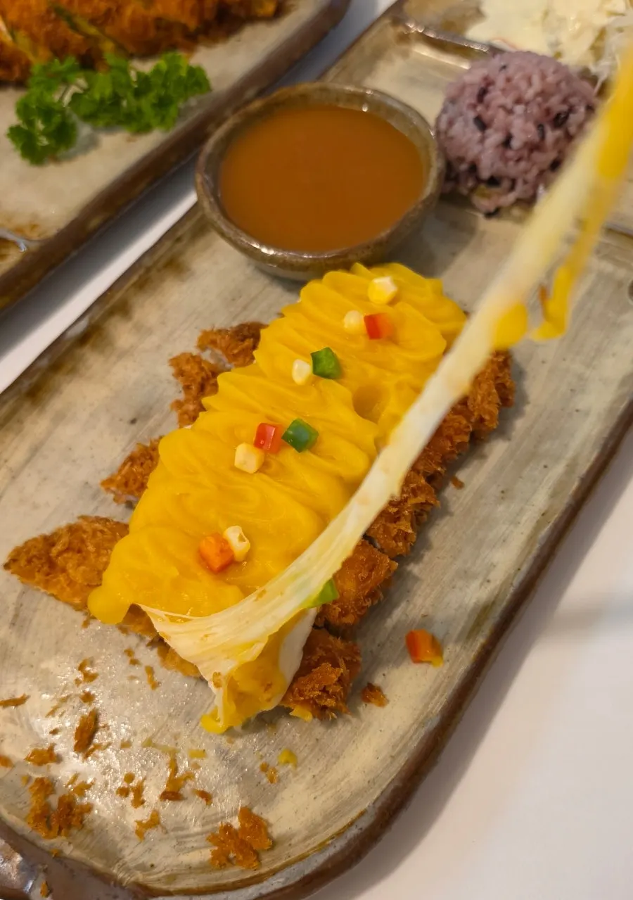 Cross-section of the sweet potato cheese pork cutlet with stretchy cheese