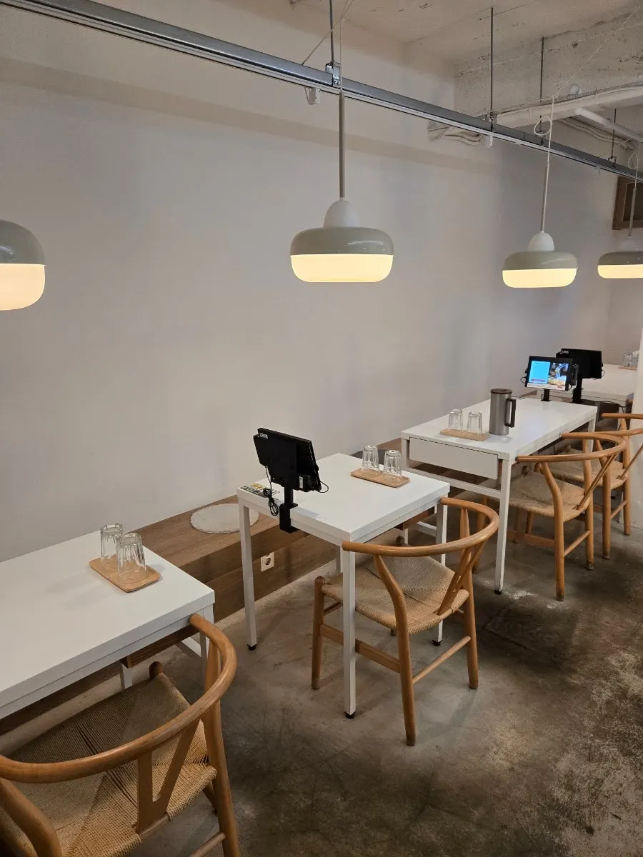 Interior of Ikki Roll Katsu decorated in wood tones and white