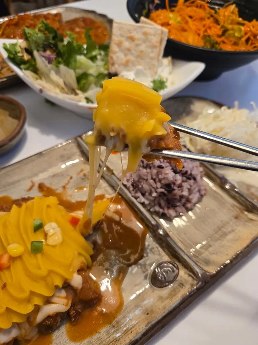 A bite of salad with ricotta cheese on a cracker
