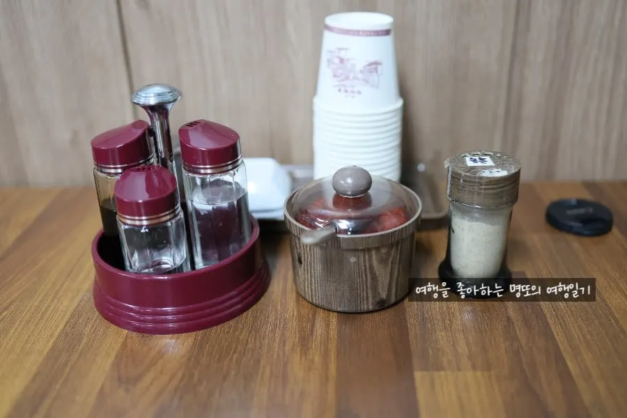 Drawer of utensils beside the table