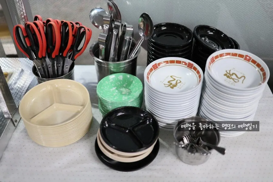 Self-serve bar with water cups and personal plates
