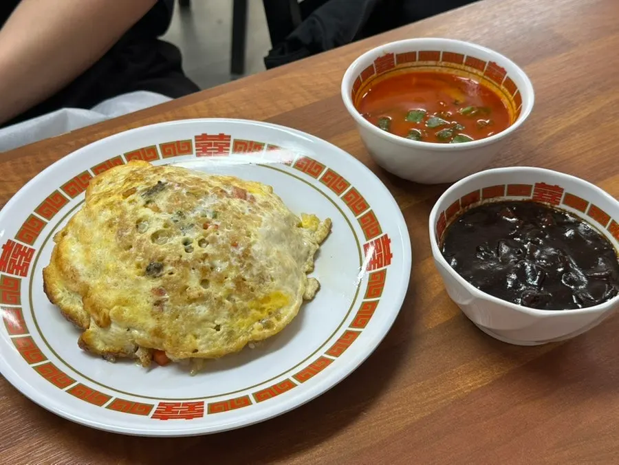 Table setting with fried rice and jjamppong broth on the side