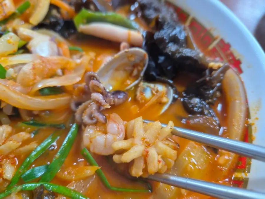 A piece of mini tangsuyuk dipped in sauce