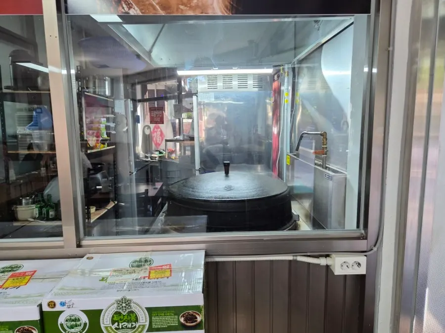 Kitchen and bone broth pot visible through the glass window