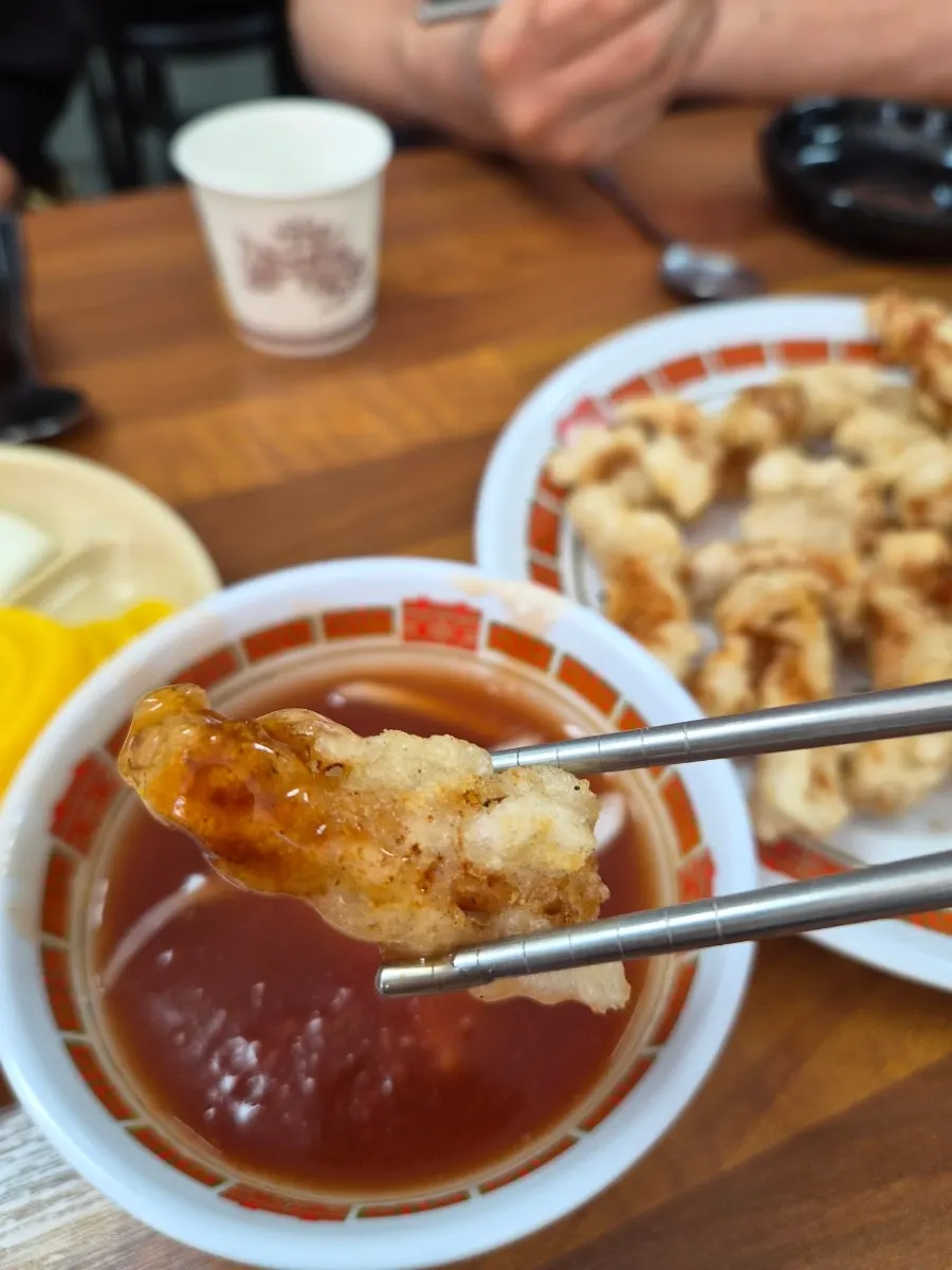 A piece of tangsuyuk dipped in sauce