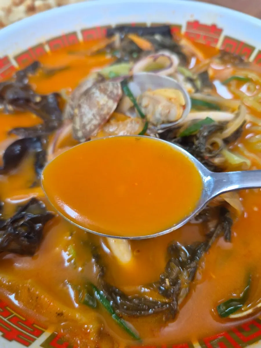 A spoonful of spicy jjamppong broth
