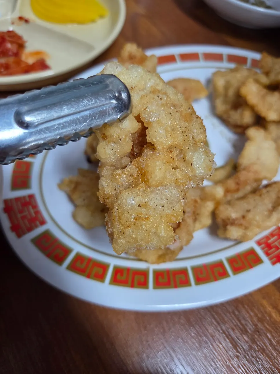 Dipping a piece of tangsuyuk into sauce