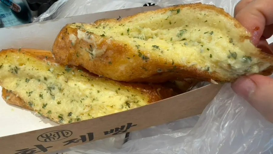 Cross-section of the fluffy garlic bread soaked with garlic sauce
