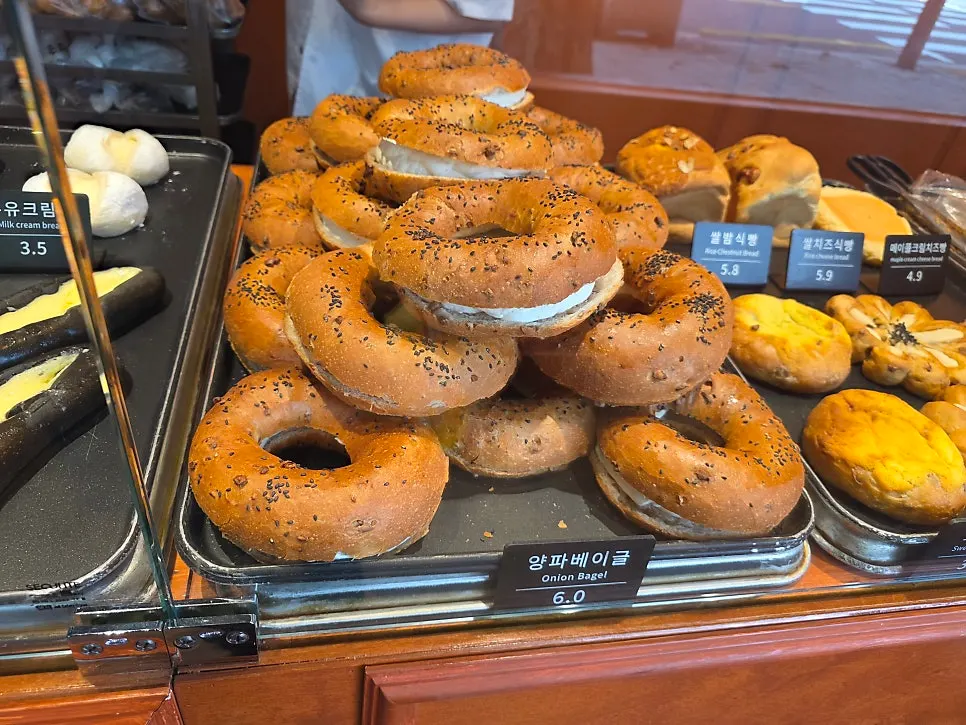 Onion bagels and loaf bread on display