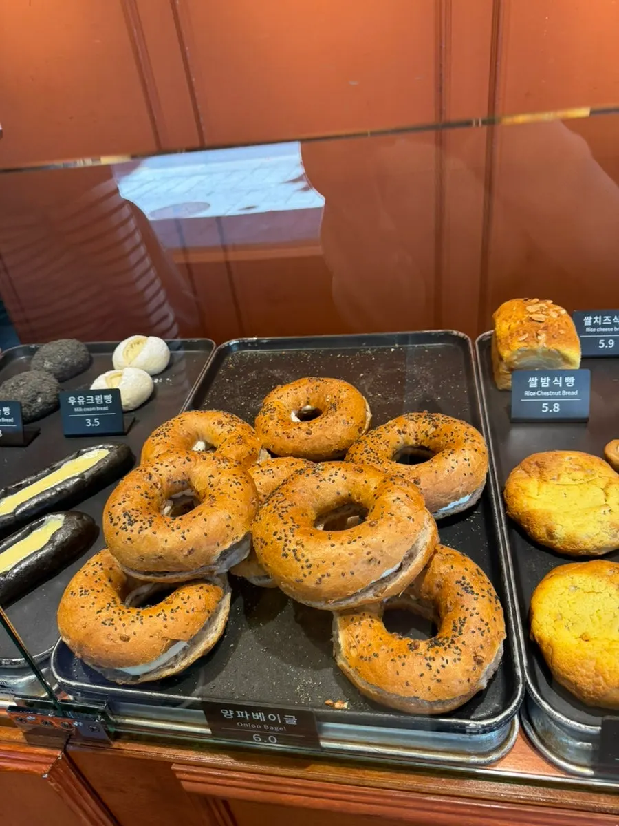 Various breads on display including onion bagel and coffee bread