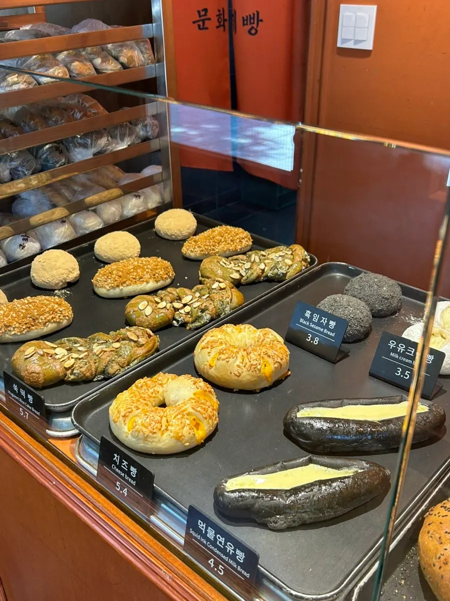 Bread display shelf and price tags at Munhwa Bakery