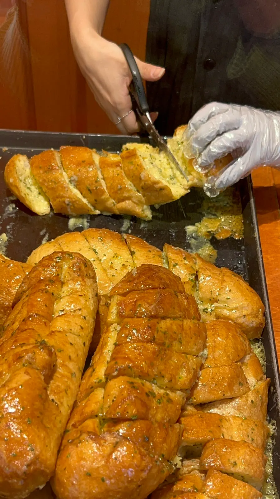 Garlic bread pieces cut with scissors and packed