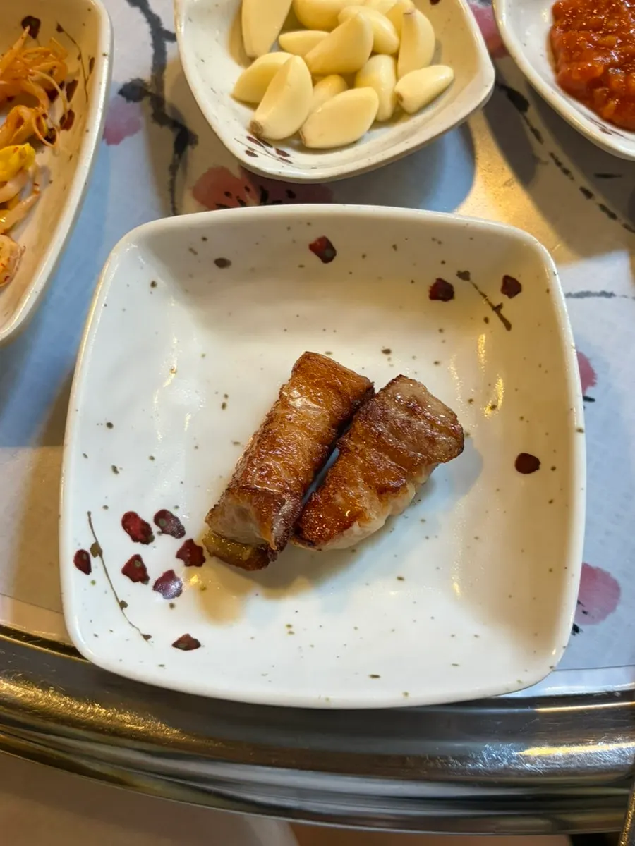 Fully grilled pork alongside side dishes