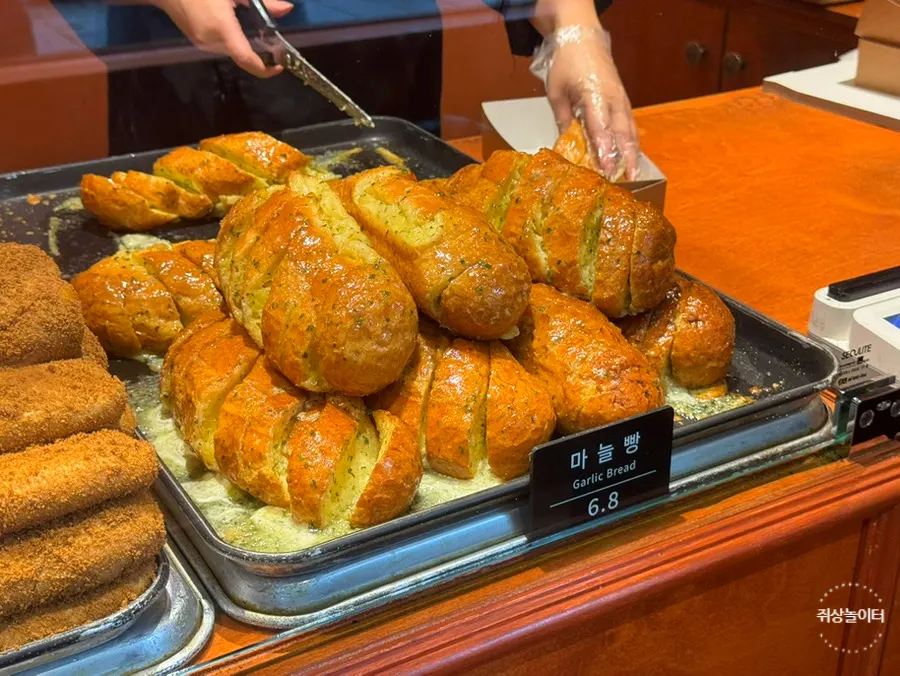 Small interior of Munhwa Bakery with a sign limiting entry to 2 parties at a time