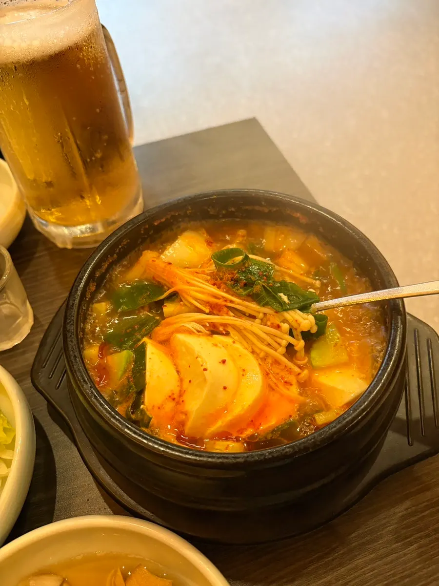 Gopchang restaurant spread served alongside the beer