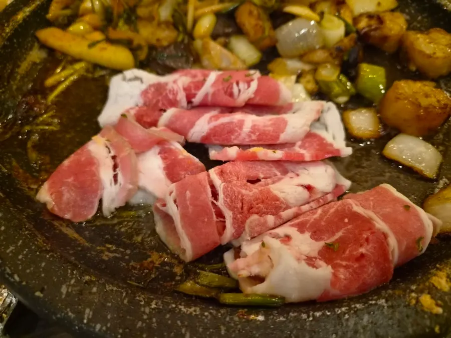 우삼겹과 곱창이 함께 놓인 불판