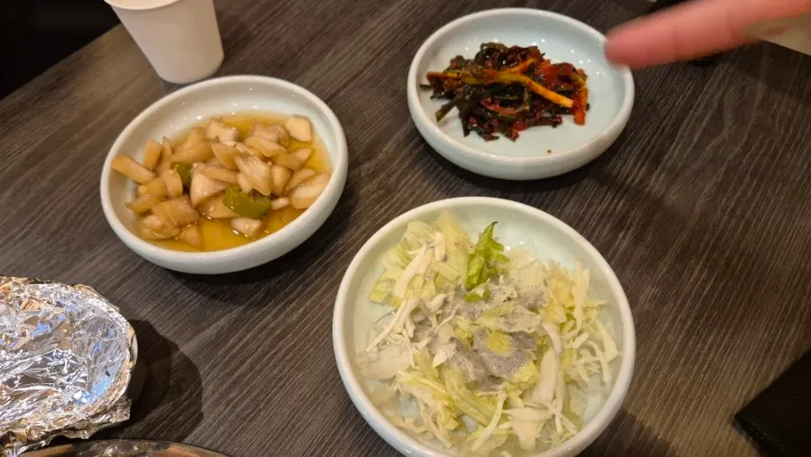 Side dishes at Ilmigop including green onion kimchi and pickled onions