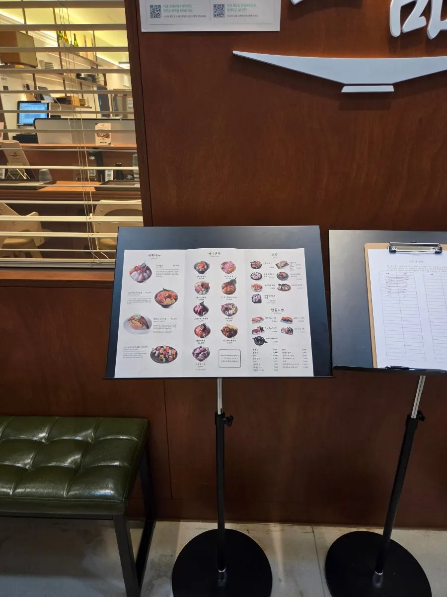 Menu board and waiting area set up in front of the restaurant