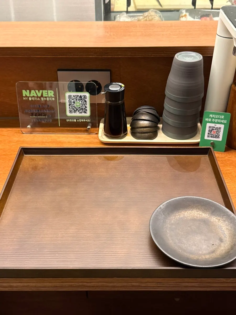 Bar seating with a tablet order system and water dispenser on the table