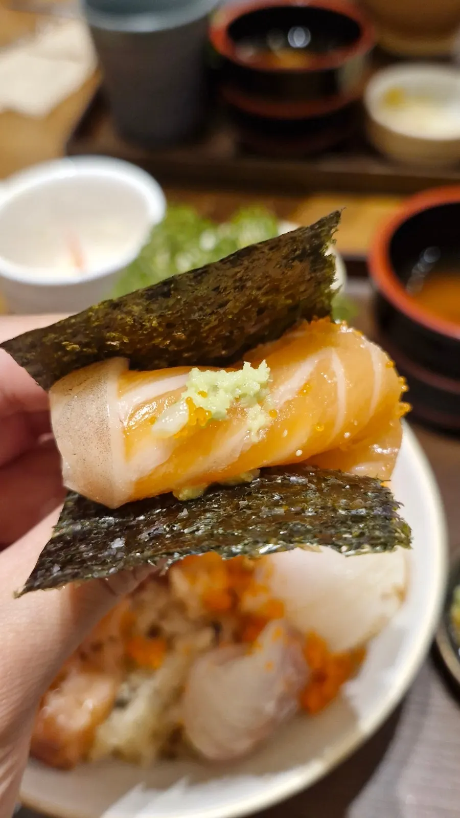 A bite of kaisendon wrapped in seaweed