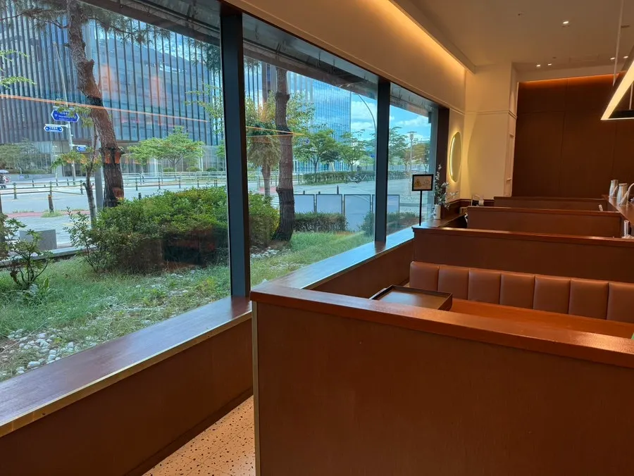 4-person table next to the floor-to-ceiling windows