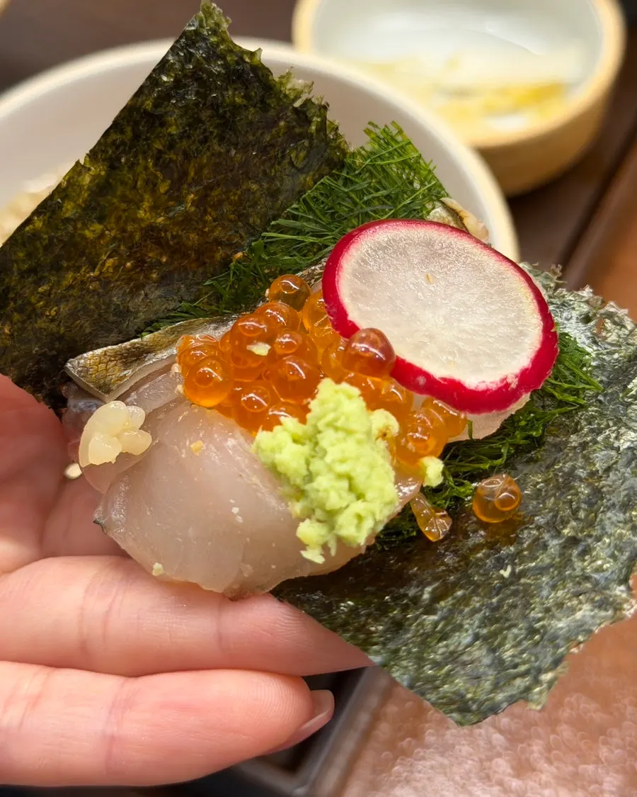 Raw salmon and seared salmon placed on rice and seaweed
