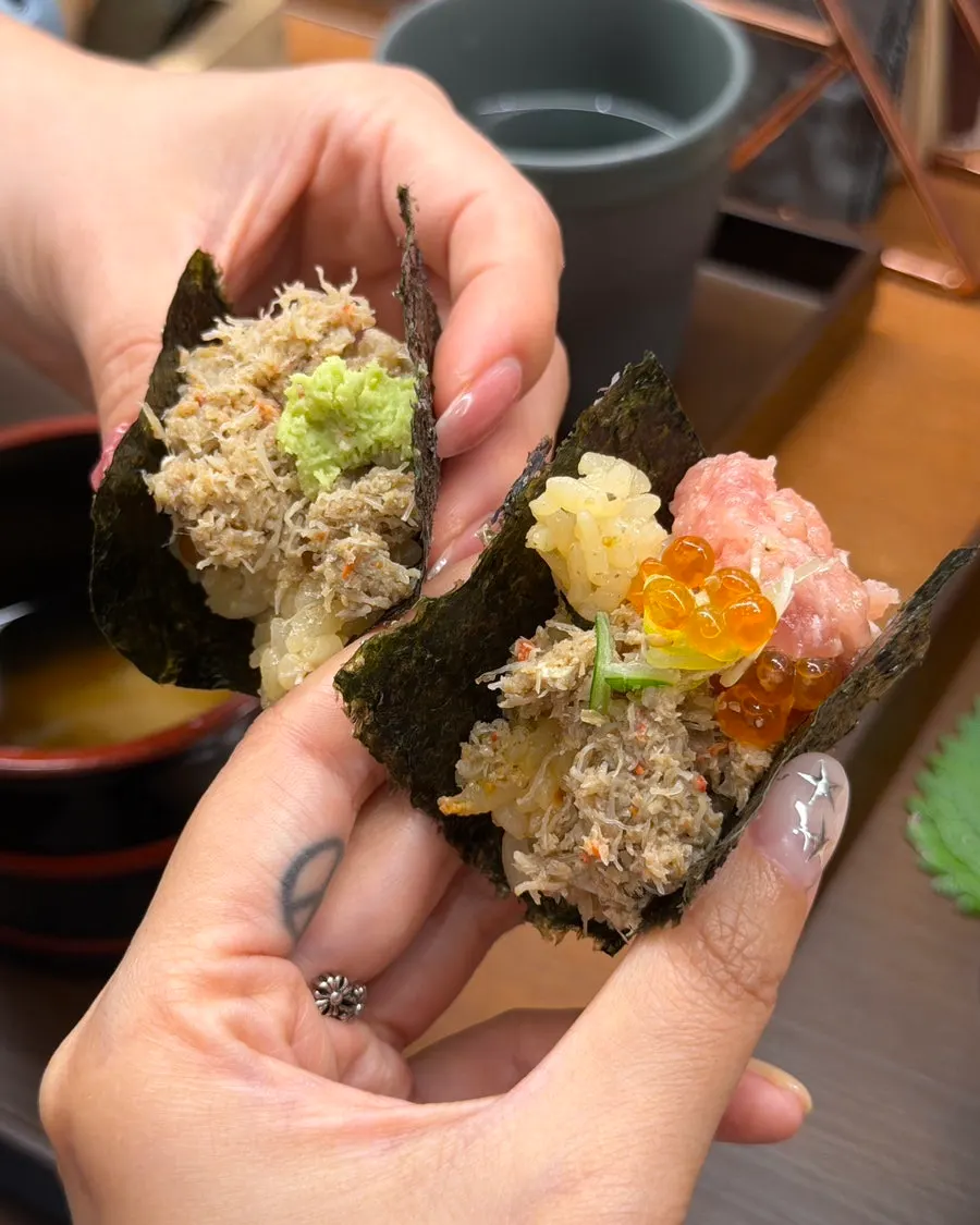 Comparing a bite of snow crab meat with a bite of negitoro and salmon roe