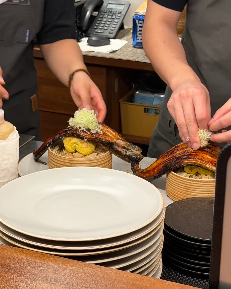 Whole eel unagidon being plated at the tachi counter