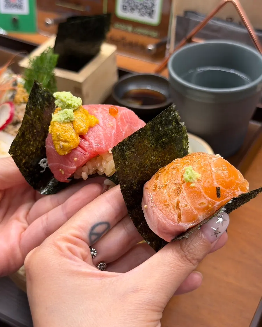 A bite of tuna and sea urchin next to a bite of seared salmon